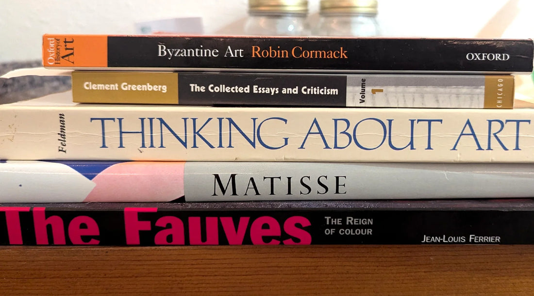 A stack of books about oil painting history, painters and movements sit atop a table in Houston, Texas.