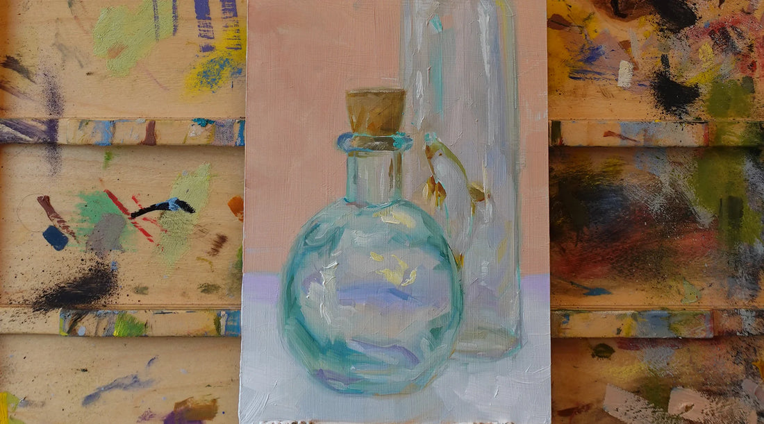 An oil painting representing two pieces of glass composed on a small panel.  The painting rests on a plein air easel with paint scattered everywhere.